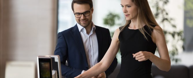Female and male walking through access control identifier