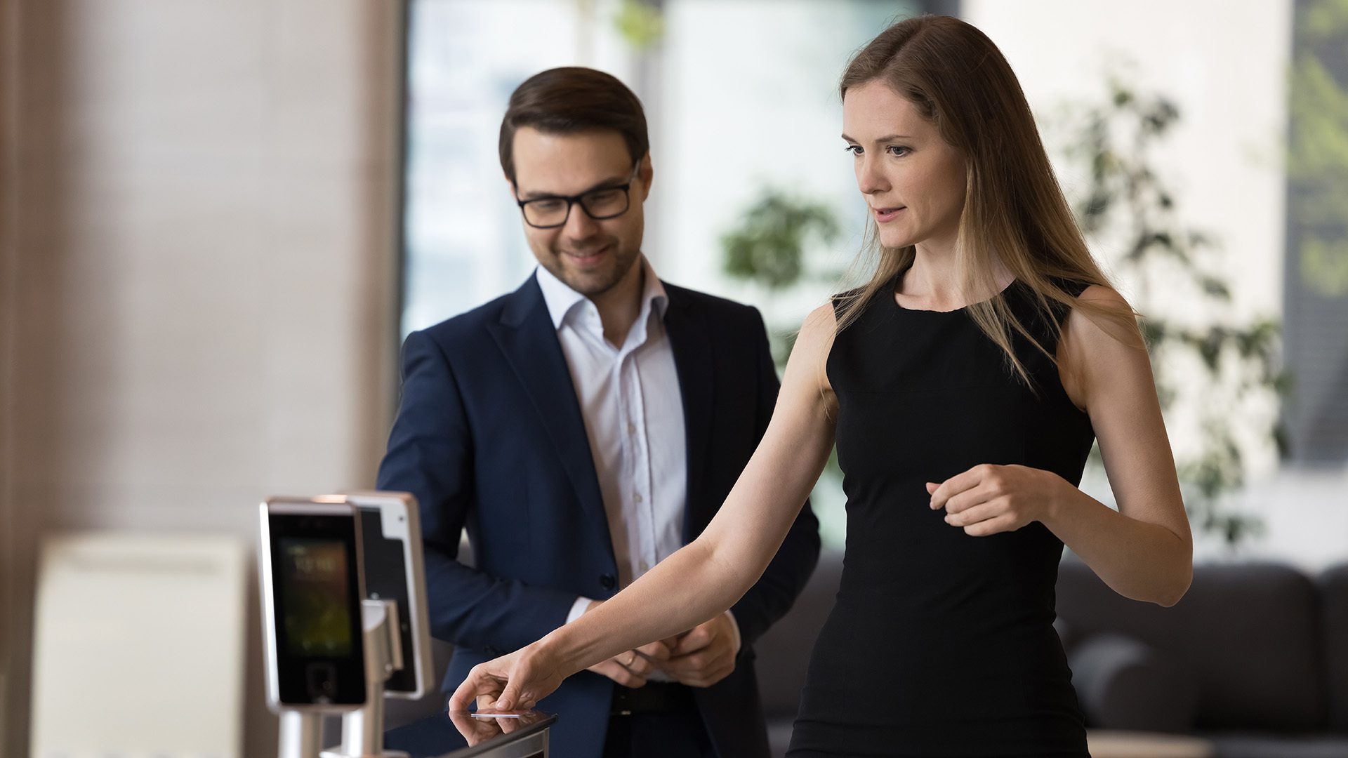 Female and male walking through access control identifier